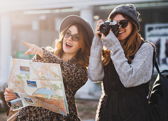 Friends looking at a map and using a camera